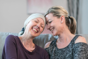 A mother and daughter share a laugh as they navigate the complexities of families dealing with cancer.