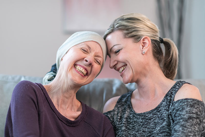A mother and daughter share a laugh as they navigate the complexities of families dealing with cancer.